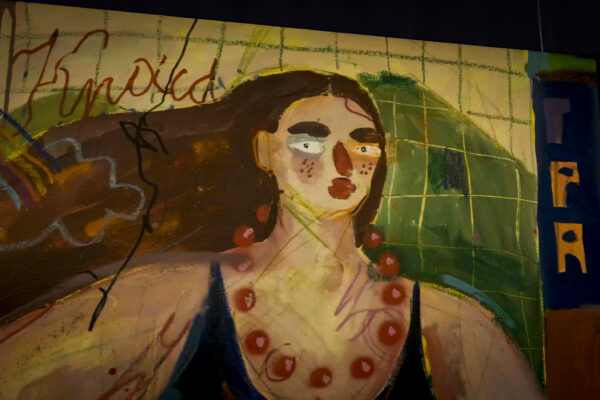 Abstract painting of a woman with a striking gaze in a graffiti-style artwork.